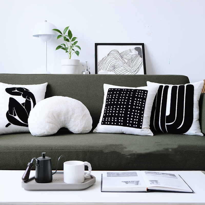 Modern cushion with waves, dots and geometric black and white pattern